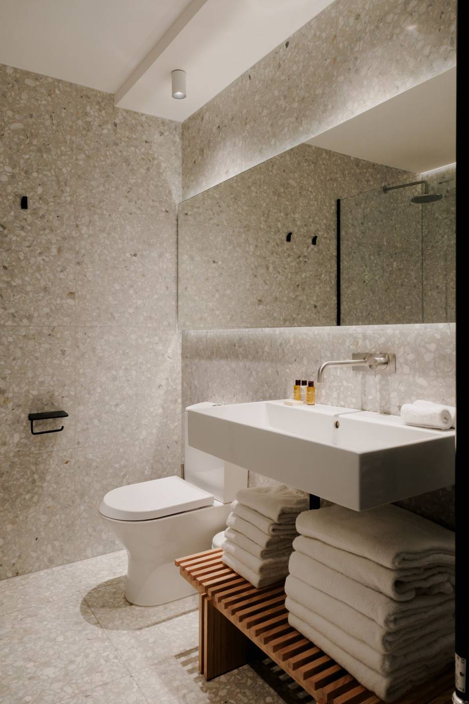 Salle d'eau en terrazzo : vasque et grand miroir